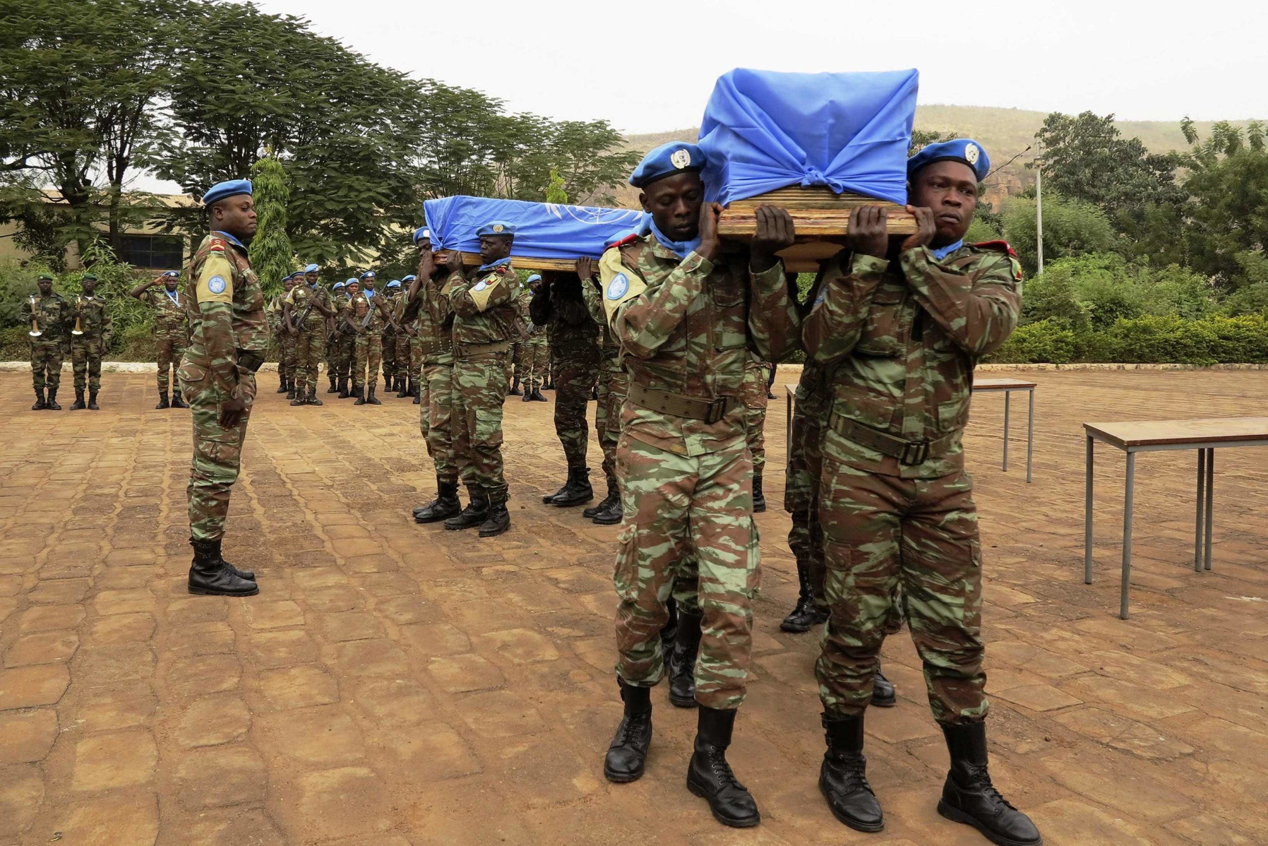 Malian and MINUSMA soldiers carry flag-draped coffins of U.N. soldiers during funeral in Bamako